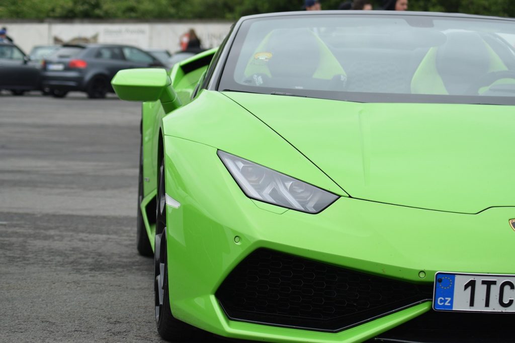 Bright green Lamborghini sports car displayed at outdoor event showcasing exotic vehicle registration and titling