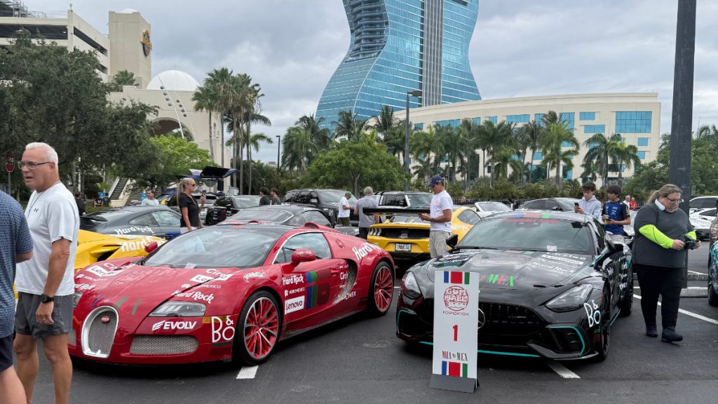 Red Bugatti supercar displayed at Gumball 3000 2026 Miami launch event with supercars lined up at Hard Rock Casino