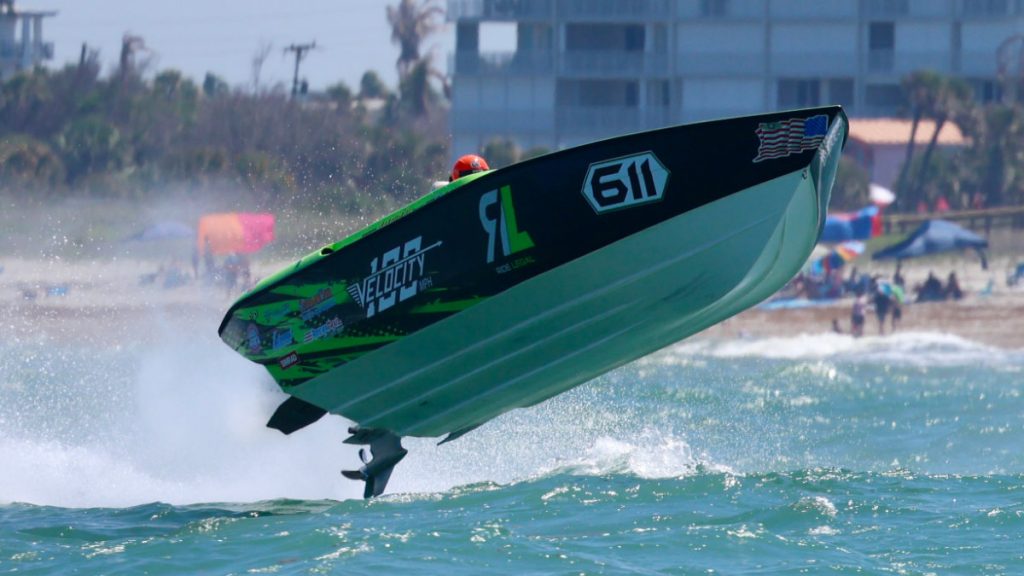 Green speedboat launching off wave at Thunder on Cocoa Beach 2026 offshore racing championship event
